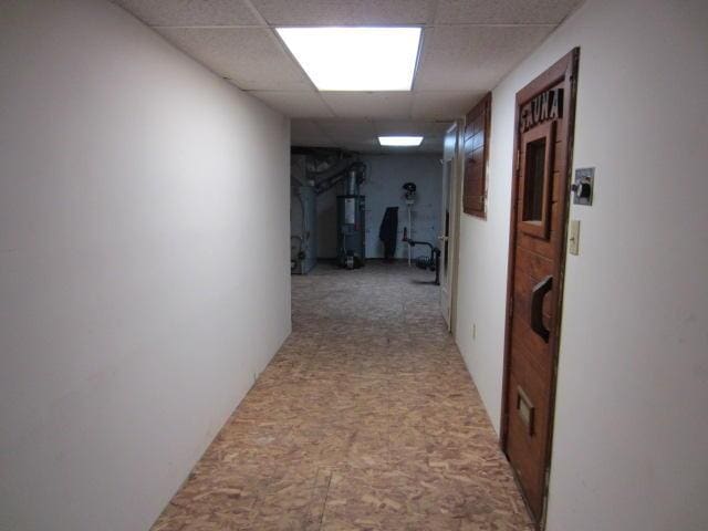 131 Clover St, Madawaska, ME 04756 - corridor with water heater and a drop ceiling