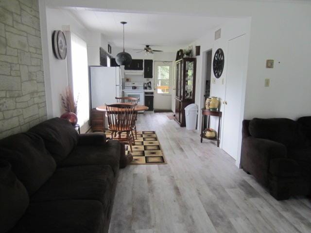 131 Clover St, Madawaska, ME 04756 - living area featuring light wood-type flooring and ceiling fan