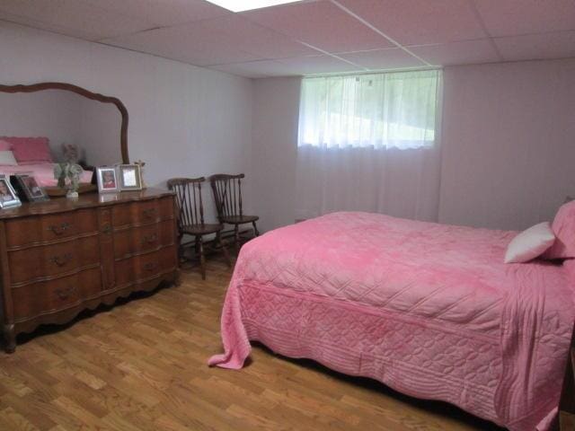 131 Clover St, Madawaska, ME 04756 - bedroom featuring a drop ceiling and wood finished floors
