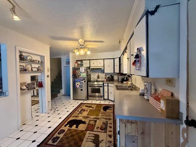 131 Clover St, Madawaska, ME 04756 - kitchen featuring light floors, appliances with stainless steel finishes, white cabinetry, a sink, and under cabinet range hood