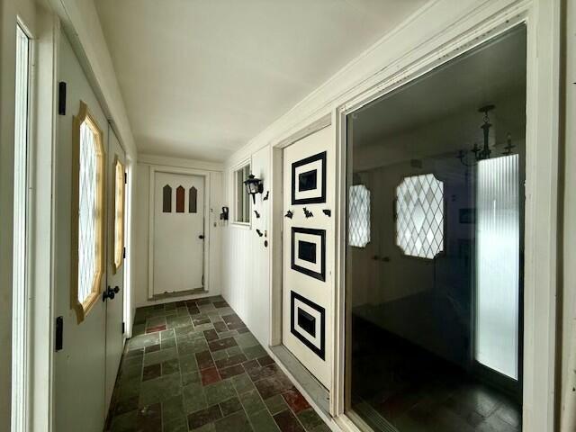 131 Clover St, Madawaska, ME 04756 - corridor featuring stone finish floor and a notable chandelier