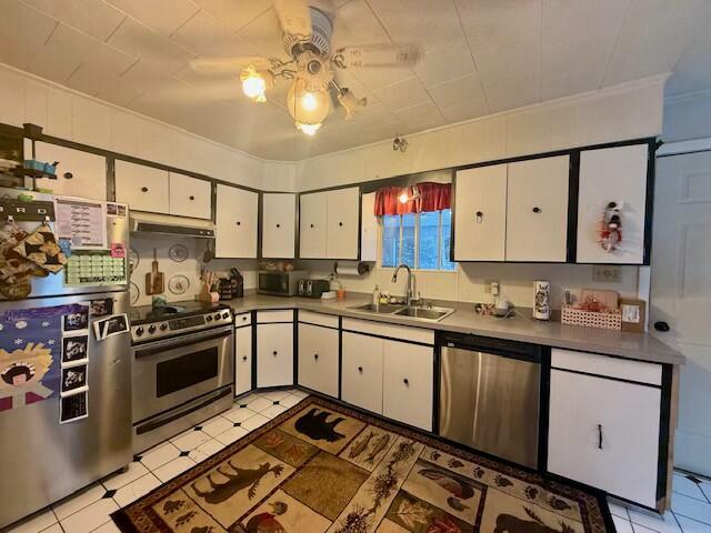 131 Clover St, Madawaska, ME 04756 - kitchen featuring stainless steel appliances, white cabinets, a sink, and under cabinet range hood