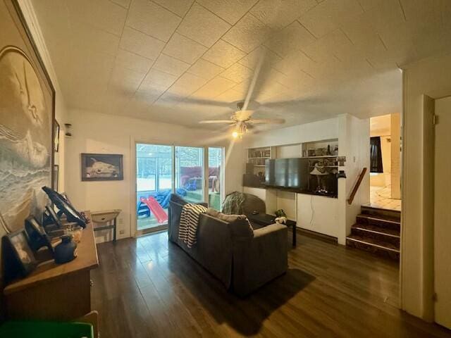 131 Clover St, Madawaska, ME 04756 - living area featuring dark wood-style floors, ceiling fan, and stairway