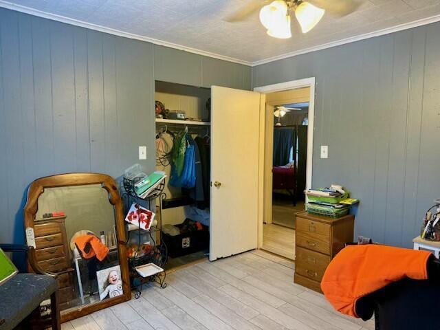 131 Clover St, Madawaska, ME 04756 - bedroom with light wood-type flooring, crown molding, ceiling fan, and a closet
