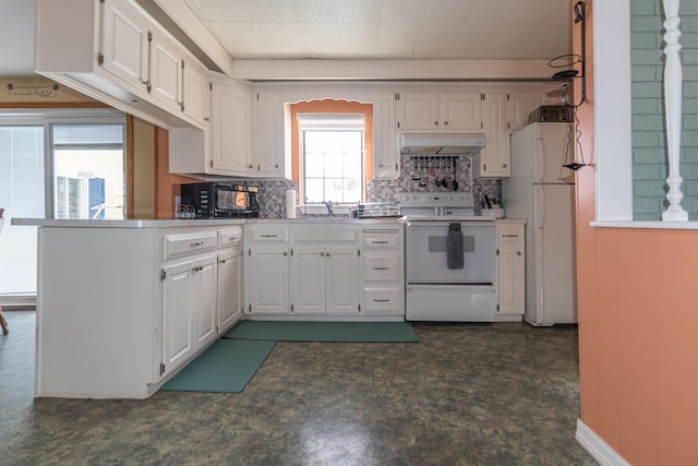 633 Main St, Madawaska, ME 04756 - kitchen featuring under cabinet range hood, a peninsula, white cabinets, and white appliances