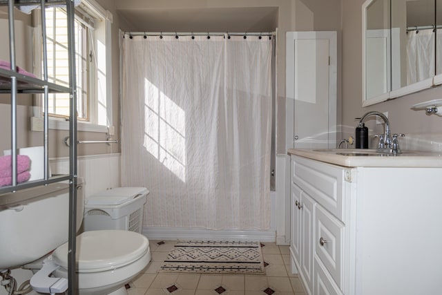 633 Main St, Madawaska, ME 04756 - bathroom featuring tile patterned floors, toilet, vanity, and shower / bath combo with shower curtain