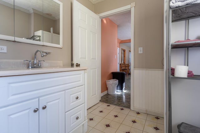 633 Main St, Madawaska, ME 04756 - bathroom featuring tile patterned floors, vanity, wainscoting, and ornamental molding