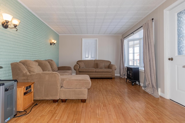 633 Main St, Madawaska, ME 04756 - living area featuring crown molding, light wood-style flooring, and an accent wall