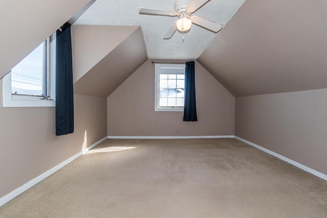 633 Main St, Madawaska, ME 04756 - additional living space featuring baseboards, lofted ceiling, a ceiling fan, and carpet floors