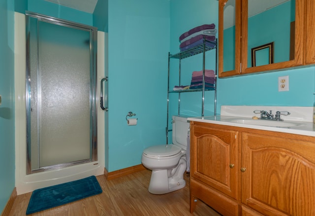 633 Main St, Madawaska, ME 04756 - bathroom with toilet, wood finished floors, baseboards, a shower stall, and vanity