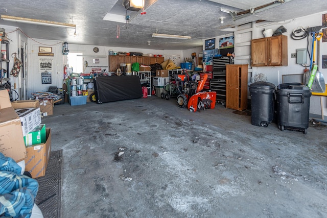 633 Main St, Madawaska, ME 04756 - garage featuring a garage door opener and a workshop area