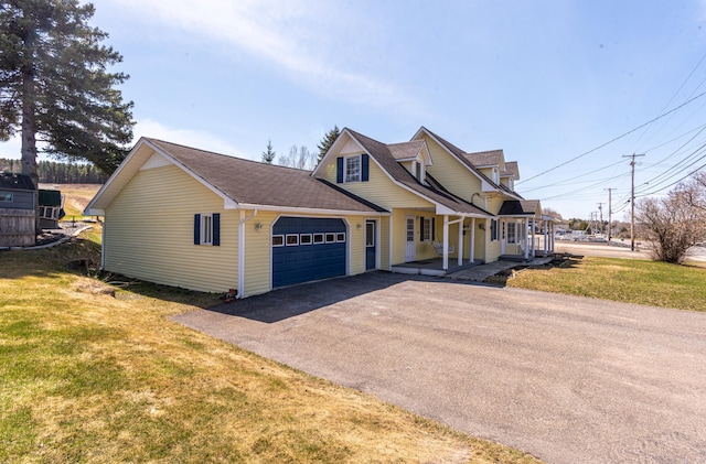 633 Main St, Madawaska, ME 04756 - traditional-style house with covered porch, an attached garage, driveway, a front lawn, and roof with shingles