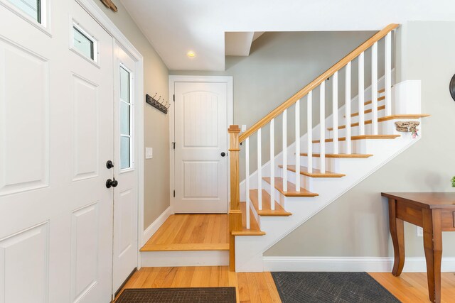 foyer entrance featuring stairway, recessed lighting, baseboards, and wood finished floors