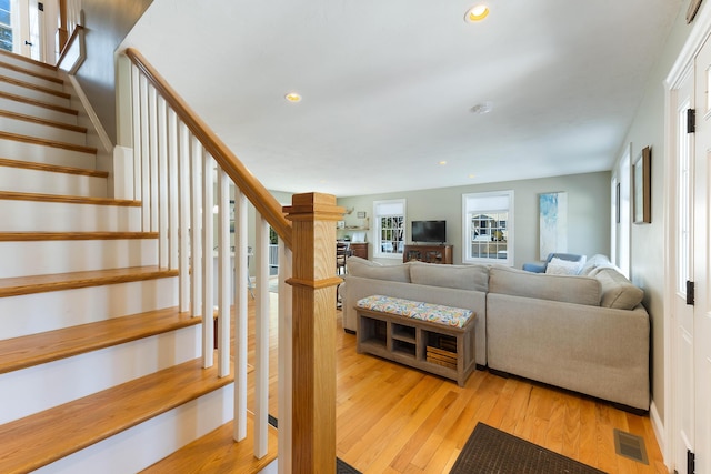 living area featuring visible vents, recessed lighting, stairway, light wood-style floors, and baseboards