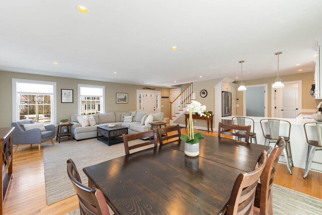 dining area featuring recessed lighting, stairway, and light wood-style flooring