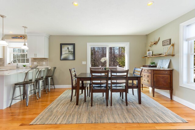 dining room featuring baseboards and light wood-style flooring