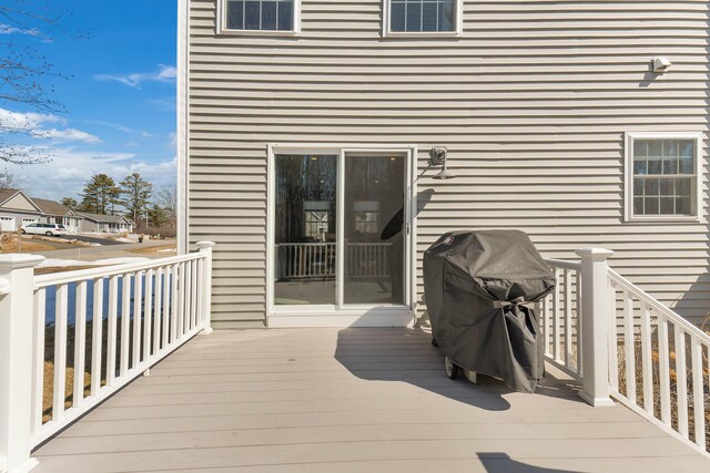 wooden terrace featuring a residential view and a grill