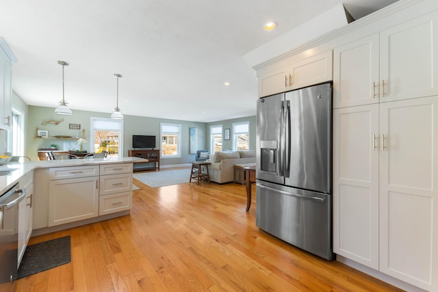 kitchen with recessed lighting, light wood-style floors, appliances with stainless steel finishes, pendant lighting, and open floor plan