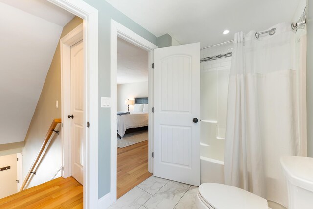 ensuite bathroom with recessed lighting, ensuite bathroom, toilet, marble finish floor, and shower / tub combo with curtain