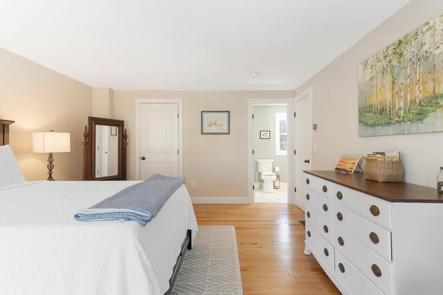 bedroom featuring ensuite bath, light wood-style floors, and baseboards