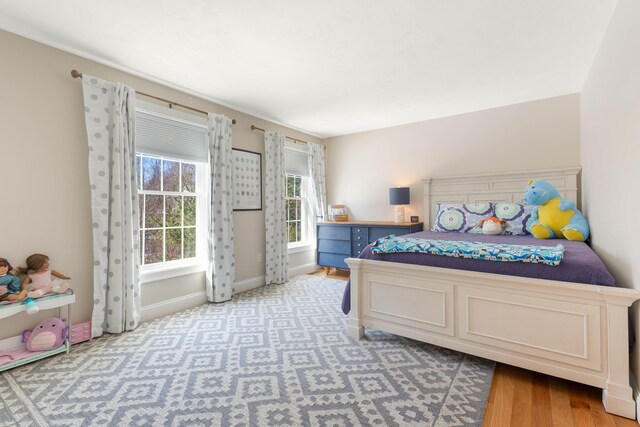 bedroom featuring baseboards and light wood-style floors