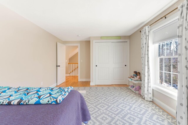 bedroom with a closet and baseboards