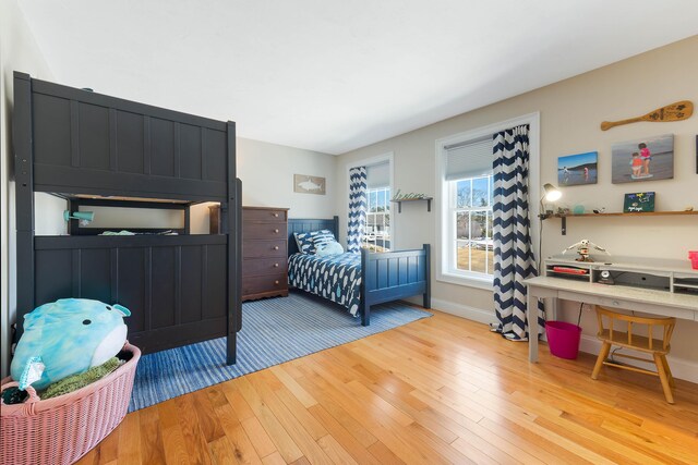 bedroom with light wood-type flooring and baseboards