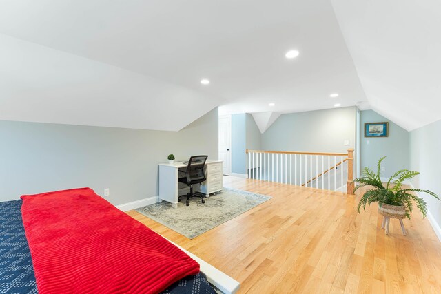 bedroom with vaulted ceiling, recessed lighting, wood finished floors, and baseboards