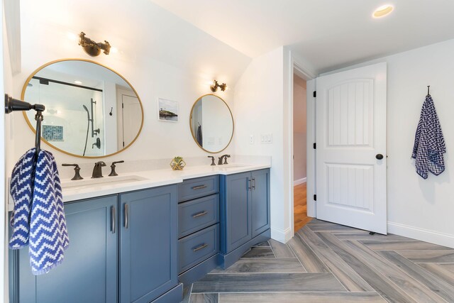 full bath featuring a sink, baseboards, and double vanity