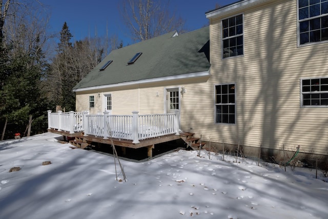 snow covered rear of property featuring a wooden deck