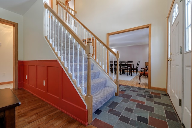 interior space featuring wood finished floors and wainscoting