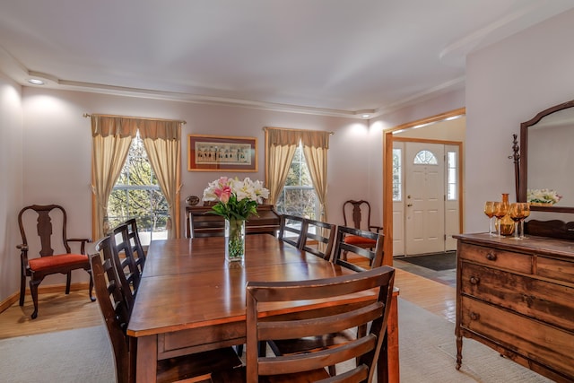 dining area with baseboards and wood finished floors