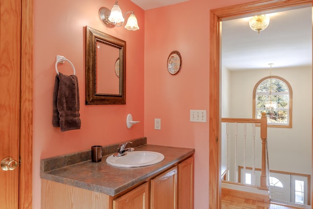 bathroom with vanity and an inviting chandelier