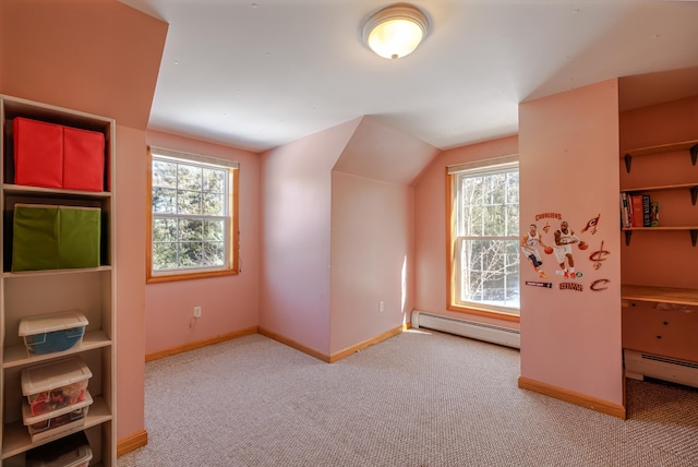 bonus room featuring carpet flooring, baseboards, vaulted ceiling, and baseboard heating