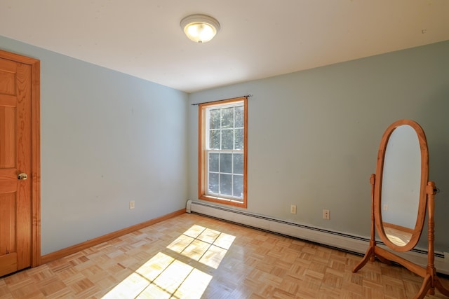 empty room with a baseboard radiator and baseboards