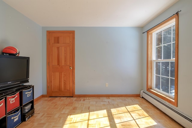 interior space featuring baseboards and a baseboard heating unit