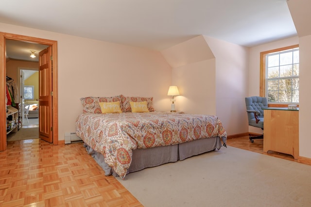 bedroom featuring a baseboard heating unit and baseboards