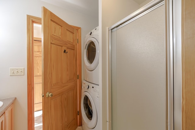 laundry area featuring stacked washer / dryer