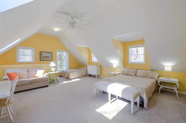 carpeted bedroom with lofted ceiling, baseboards, and a ceiling fan