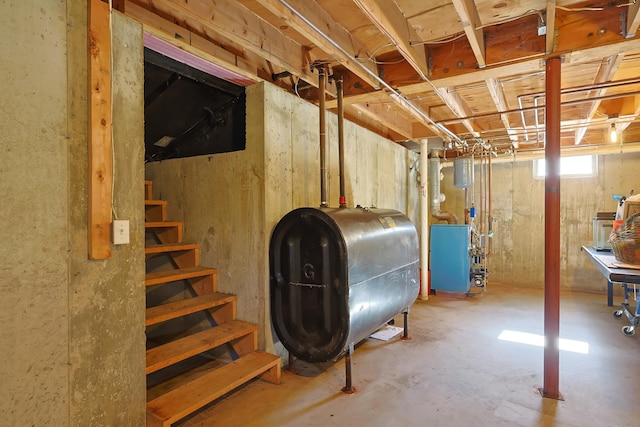 below grade area with heating fuel, stairway, and a heating unit