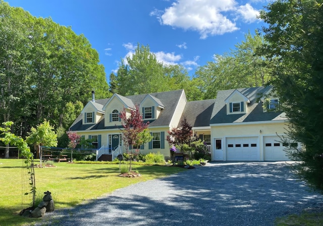 cape cod-style house with an attached garage, driveway, and a front yard