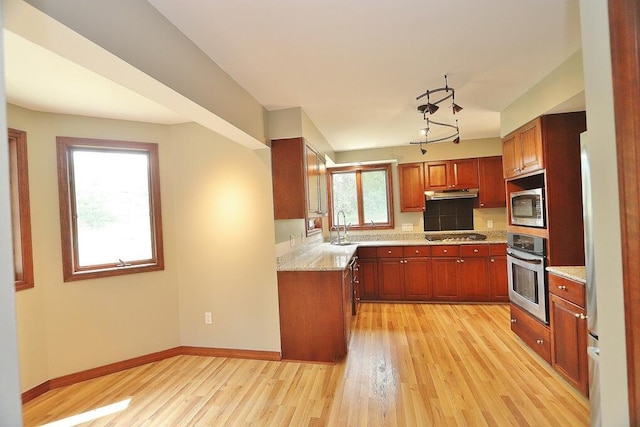 220 Church Rd, Bangor, ME 04401 - kitchen featuring under cabinet range hood, appliances with stainless steel finishes, light wood finished floors, and a sink