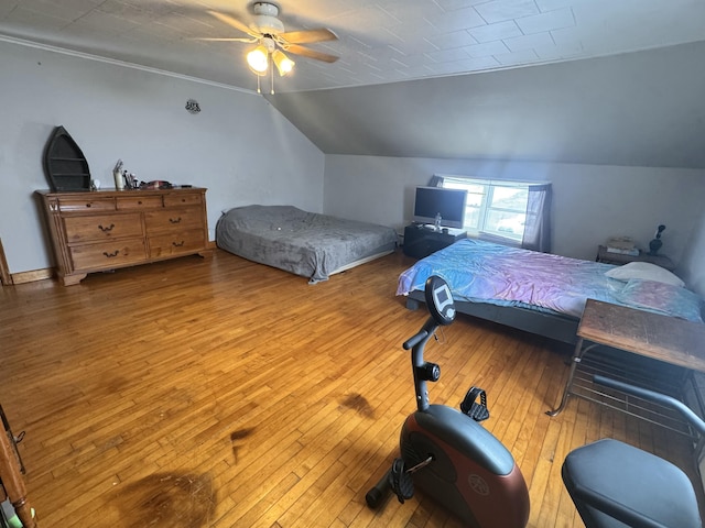 bedroom featuring a ceiling fan, lofted ceiling, and wood-type flooring