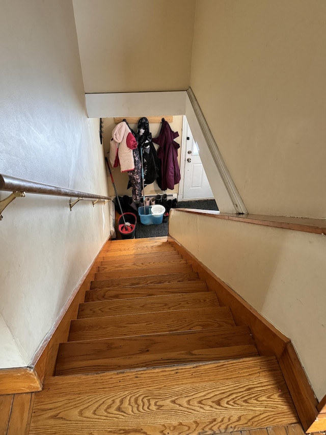 stairs featuring wood finished floors