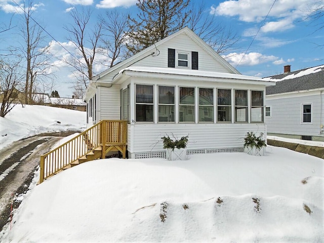 view of front of home featuring a sunroom