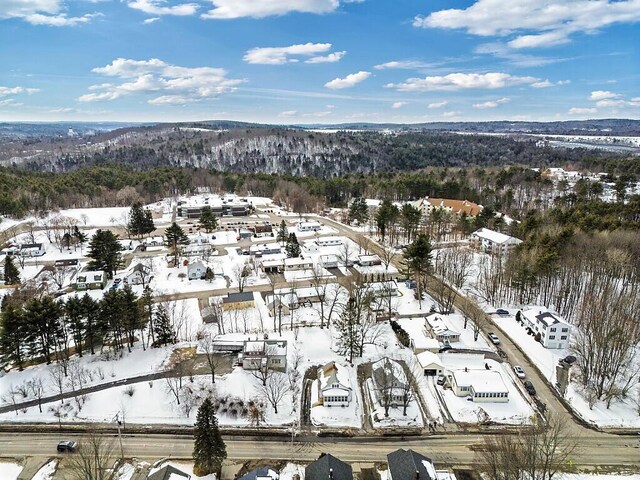 snowy aerial view with a residential view