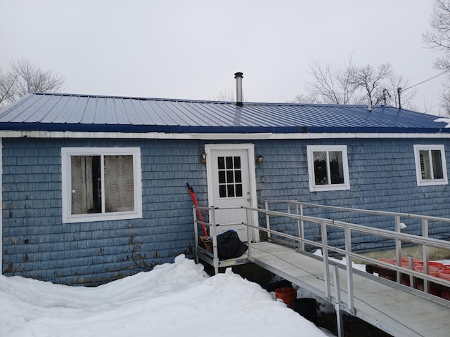 ranch-style home featuring metal roof