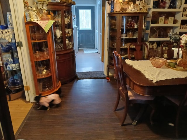 dining space with wood finished floors