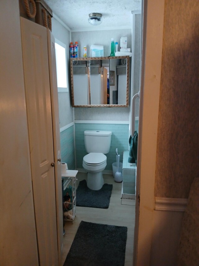 bathroom featuring a textured ceiling and toilet