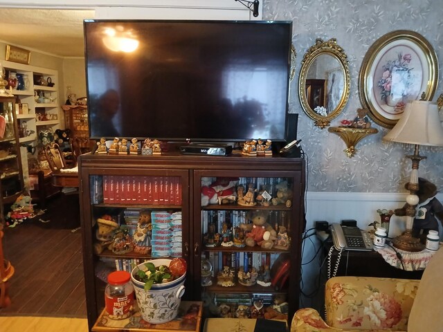 interior space featuring wainscoting, wood finished floors, and wallpapered walls